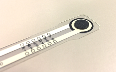 Example of a load concentrator adhered to a FlexiForce A201 sensor.